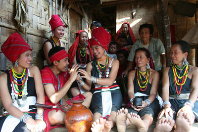 A Kayah bride offers millet wine to her husband.