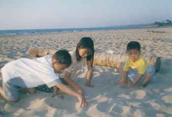 Kaw Kaw plays on a Beach inside Burma during a school holiday in 1999. Photo credit: Contributed