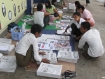 Generally unpopular Burma's state-owned newspapers are being read with great interest these days. Rangoon residents reading today's newspapers. Photo: Mizzima.