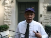 An official from the Permanent Mission of Burma to the United Nations in New York, his ID pass hidden in his top pocket, confronts protesters from Amnesty International and Burma Point after they placed at the mission’s entrance flowers and posters featuring the image of opposition leader Aung San Suu Kyi in honour of her 65th birthday on June 19, 2010. He had put his foot on Suu Kyi’s face pictured on the poster while clearing away the flowers also with his feet, highly offensive acts in Burmese culture. Photo: Mizzima.