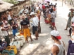 Scores of people wait for water to be delivered by charities in Dala Township, across the river from central Rangoon, on May 14.Mizzima News