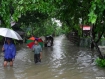 Pedestrians wade along a flooded street near Maungdaw Hospital, Arakan State, on Tuesday, June 15, 2010. Heavy rain at around 10 a.m. on Monday continued for 12 hours, led to flooding in all four quarters of the town and forced the evacuation of more than 100 homes to High School No. 1 on higher ground. The Naf River runs to the west of Maungdaw, with tributaries to the north and south of the port town. Photo: Nyein Chan/Mizzima