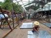 A sheet-metal worker on June 15 prepares to cut materials for a temporary building for vendors from the 406 shops at Chindwin Yadana Market in Monywa gutted by fire. Temporary shops are being set up at a new location on Nyaungdapin Road in the township northwest of Mandalay. Photo: Mizzima