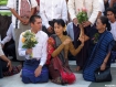Pro-democracy leader Aung San Suu Kyi and her youngest son Kim Aris, aka Htein Lin, prepare to pay homage to Buddha with flowers at Shwedagon Pagoda in Rangoon early on Wednesday, November 24, 2010. Suu Kyi, reunited with her son after a decade the day before, and other visitors exchanged friendly greetings at the 2,500-year-old landmark in the centre of the former Burmese capital. Photo: Mizzima.