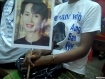 Supporters of detained opposition leader Aung San Suu Kyi gather outside her National League for Democracy headquarters in Rangoon on Friday November 12, 2010, wearing T-shirts and bearing banners with her portrait. Reports emerged that officials said she would be released this afternoon, a day before her 18-month house-arrest sentence was to be lifted. Key supporters are also waiting outside her lakeside home in the city. Photo: Mizzima.