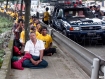 Security police photograph protesters as they chant 'loving kindness' prayers in Rangoon on Monday, September 26, 2011. The protesters were prevented from walking to Shule Pagoda and dispersed. Photo: Mizzima 