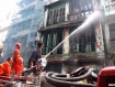 Firemen spray water on a fire in a three-story building where a 77-year-old man lost his life in Latha Township in Rangoon on Wednesday, July 13, 2011. Photo: Mizzima