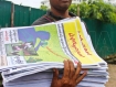 A journal vendor carries a copy of 'People’s Era Journal' on Tuesday, September 6, 2011. The journal includes an article written by Burma’s opposition leader Aung San Suu Kyi about her recent personal pilgrimage to Bagan and an article by Win Tin, a National League for Democracy leader, titled “Fifth Pillar” about the role of the media in society. Photo: Mizzima 