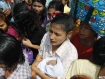 A woman holds a newborn baby as she waits for the release of prisoners in front of Insein Prison in Rangoon. The new government has commuted the sentence of all prisoners by one year, and they are scheduled to be released on Tuesday, May 17. Photo: Mizzima