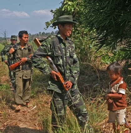 An ethnic rebel and his five-year-old son after fleeing attacks in their village in Burma. Photo: Steve Sanford/IRIN