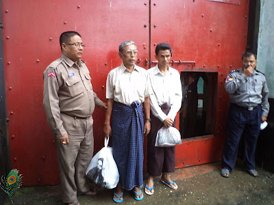 Two NGO workers with AZG, a Netherlands-based NGO, Kyaw Hla Aung, in blue longyi, and Win Naing, in red longyi, were released from a prison in Sittwe Prison on Thursday, August 16, 2012. Burmese Minister Khin Yi said that 10 workers with international NGOs were arrested in connection with Rakhine-Rohingya violence. Photo: Mizzima