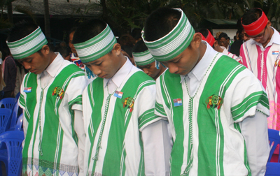 Karen youth bow in unity to honor their national flag. 