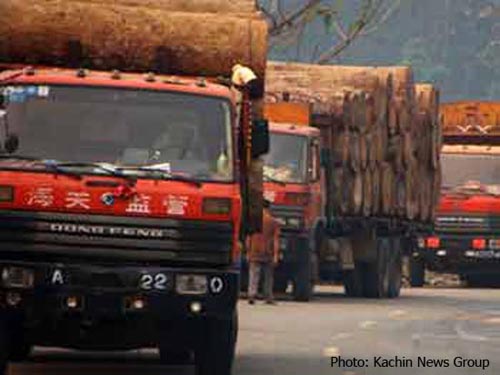 Chinese timber trucks cross the border from Kachin State in northern Burma to China's Yunnan province timber