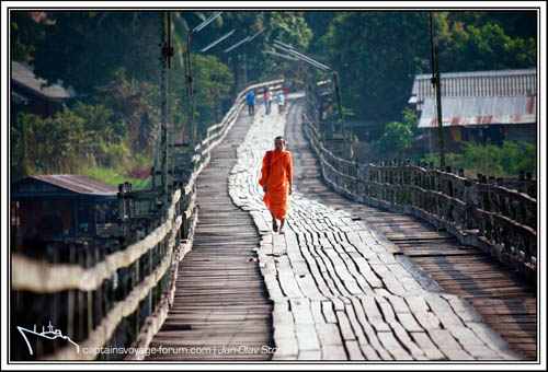A monk crosses the Sangkhale River on the wooden bridge. bridge_and_monks_-2