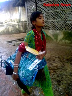 A Young refugee carrying mosquito packets refugee-net