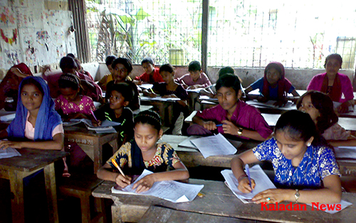 Refugee students sit in the examination in camp school sitting-in-exam