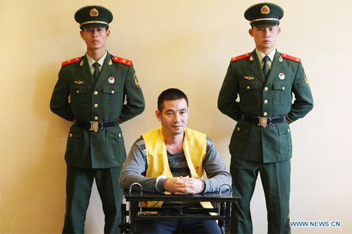 Naw Kham (C), a drug lord suspected of masterminding the murders of 13 Chinese sailors on Oct. 5, 2011, is interrogated by Chinese and Myanmar military and police officers in Kunming, capital of southwest China's Yunnan Province, Aug. 22, 2012. A team of Myanmar military and police officers arrived Wednesday in Kunming to interrogate Naw Kham, who is believed to be associated with the Mekong River murders in October 2011, at the invitation of China's Ministry of Public Security. (Xinhua/Li Fangyu)