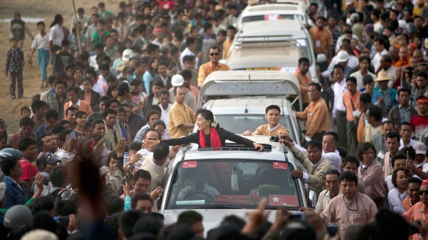 Opposition leader Aung San Suu Kyi reaches for supporters as she leaves after a public meeting close to Letpadaung mine in Monywa, northwestern Myanmar, Friday, Nov. 30, 2012. (AP / Gemunu Amarasinghe)