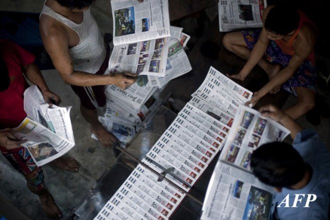 Workers check copies of a daily newspaper at a printing house in Yangon early on September 6, 2013. Privately owned daily newspapers have been available since April 1 in Myanmar under new freedoms that represent a revolution for a media industry which was shackled under military rule. AFP PHOTO Workers check copies of a daily newspaper at a printing house in Yangon early on September 6, 2013. Privately owned daily newspapers have been available since April 1 in Myanmar under new freedoms that represent a revolution for a media industry which was shackled under military rule. AFP PHOTO
