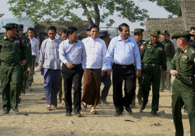 Myanmar vice president Nyan Tun (L-C), Prime Minister of Rakhine State Hla Maung Tin (C) and Union Minister of Immigration Khin Ye (R-C) walk together with high-ranking military officers as they arrive to check taking Myanmar's nationwide census at Bu Min Muslim majority village near Sittwe of Rakhine State, western Myanmar, 30 March 2014. EPA/NYUNT WIN Myanmar vice president Nyan Tun (L-C), Prime Minister of Rakhine State Hla Maung Tin (C) and Union Minister of Immigration Khin Ye (R-C) walk together with high-ranking military officers as they arrive to check taking Myanmar's nationwide census at Bu Min Muslim majority village near Sittwe of Rakhine State, western Myanmar, 30 March 2014. EPA/NYUNT WIN