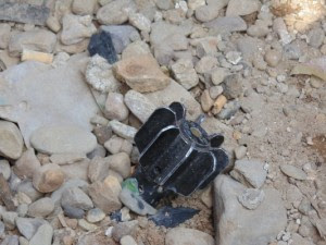 An unexploded mortar shell beside a villager's house (Photo-SHRF)