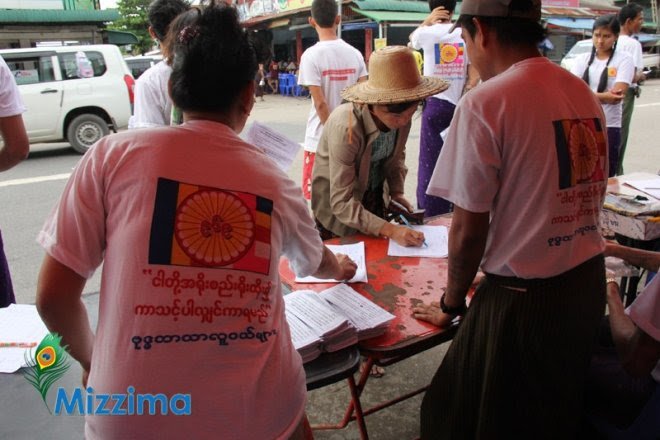 Residents of Yangon's North Okkalapa Township sign a petition to ban marriage between Buddhists and non-Buddhists on July 11, 2013. Photo: Hein Htet/Mizzima speaker outlines procedure for debate on inter-faith marriage laws