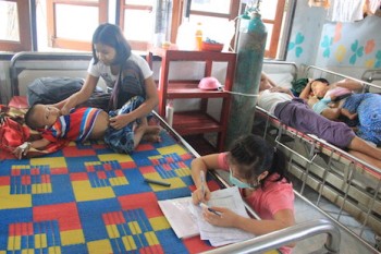 A health worker at the Mae Tao Clinic fills out a chart for a new patient Photo by Ryan Dagur
