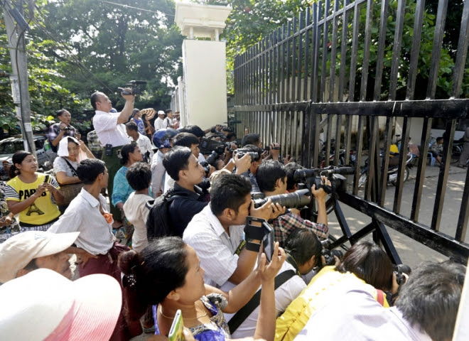 Members of the media wait outside the Insein Prison in Yangon