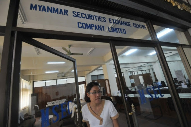 A woman leaving the Myanmar Securities Exchange Center (MSEC) in Yangon AFP PHOTO/ Soe Than WIN A woman leaving the Myanmar Securities Exchange Center (MSEC) in Yangon AFP PHOTO/ Soe Than WIN