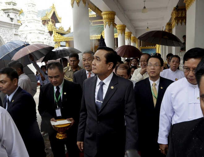 Thailand's newly-appointed Prime Minister Prayuth Chan-ocha, centre, arrives at the Shwedagon Pagoda, Yangon October 10. General Prayuth made his first official overseas trip to Myanmar October 9-10 Myanmar leader asks Thai PM for fair probe on tourist murders