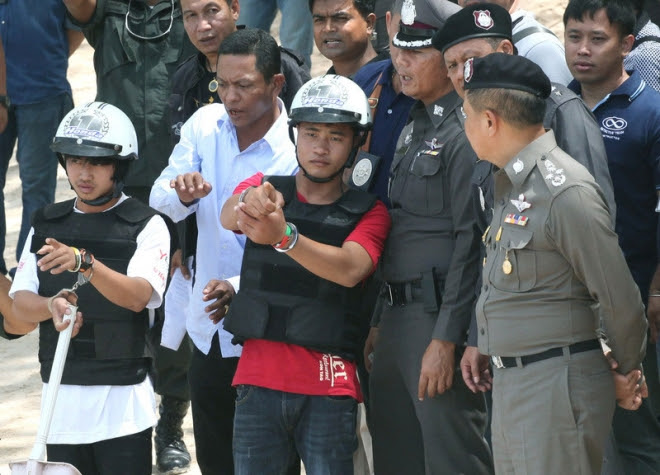 Thai police officers look on as two Myanmar migrant workers - suspects in the killing of two British tourists - participate in a crime re-enactment on the beach of Koh Tao island in Surat Thani province, southern Thailand, 03 October 2014. DNA tests on two of three suspects in the killing of two British tourists have matched those found on the victims' bodies, a police source said. Both suspects are wearing helmets EPA/STR Thai police officers look on as two Myanmar migrant workers - suspects in the killing of two British tourists - participate in a crime re-enactment on the beach of Koh Tao island in Surat Thani province, southern Thailand, 03 October 2014. DNA tests on two of three suspects in the killing of two British tourists have matched those found on the victims' bodies, a police source said. Both suspects are wearing helmets EPA/STR