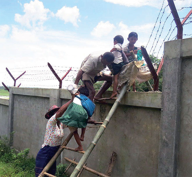 ပဲခူးမြို့၊ အမှတ် (၁) ခဲယမ်းမီးကျောက်တပ်သိမ်းမြေတွင် ခတ်ထားသည့်တံတိုင်းကြောင့် စာသင်ကျောင်းကို ခက်ခဲစွာသွားလာနေရသည့် ကလေးငယ်များကို တွေ့ရစဉ်။ (ဓာတ်ပုံ - စုစုနွေးဖေ့စ်ဘွတ်ခ်) ပဲခူးမြို့၊ အမှတ် (၁) ခဲယမ်းမီးကျောက်တပ်သိမ်းမြေတွင် ခတ်ထားသည့်တံတိုင်းကြောင့် စာသင်ကျောင်းကို ခက်ခဲစွာသွားလာနေရသည့် ကလေးငယ်များကို တွေ့ရစဉ်။ (ဓာတ်ပုံ - စုစုနွေးဖေ့စ်ဘွတ်ခ်)