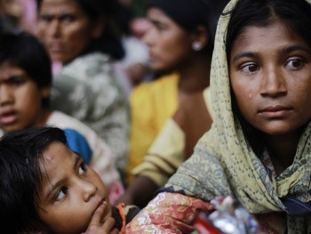 A woman displaced by the violence in the Kyukphyu township cries after arriving to Thaechaung refugee camp outside of Sittwe on 28 October 2012