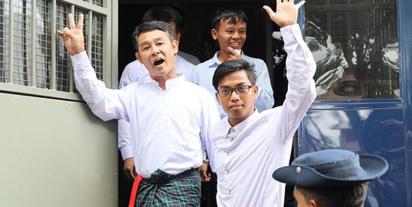 Journalists Aye Nai (L) and Lawi Weng (C) and Pyae Phone Aung (front R) leave the courthouse after appearing for a hearing in Hsipaw in Shan State on July 28, 2017. Photo: AFP