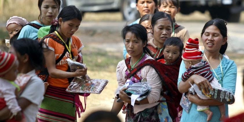 War victims who fled from the conflict zone, receive clothes and footware as they gather in a monastery which is being set up as a temporary refugee camp in Kyaukme, northern Shan State, Myanmar, 20 February 2016. Photo: Hein Htet/EPA