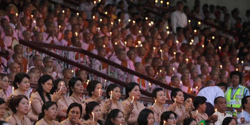People hold candles during the Interreligious Gathering of Prayer for Peace ceremony at Yangon football stadium on 10 October 2017. Photo: Thura/Mizzima