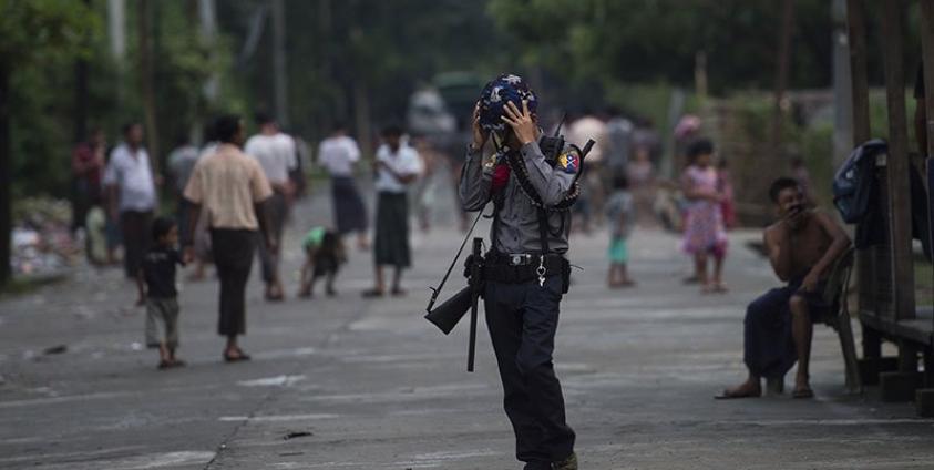 An armed Myanmar police officer stands guard in Aung Mingalar ward in Sittwe, the capital of Rakhine State. Photo: AFP