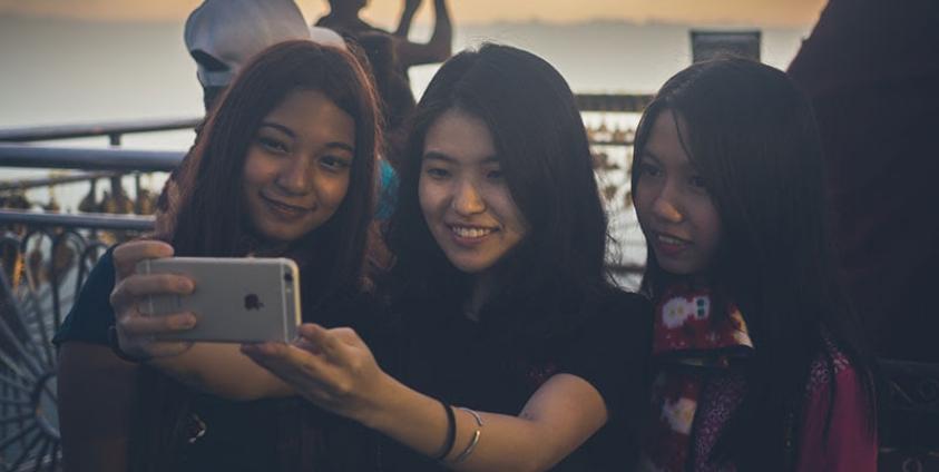 Tourists take a selfie at the Golden Rock. Photo: Ernest Chan