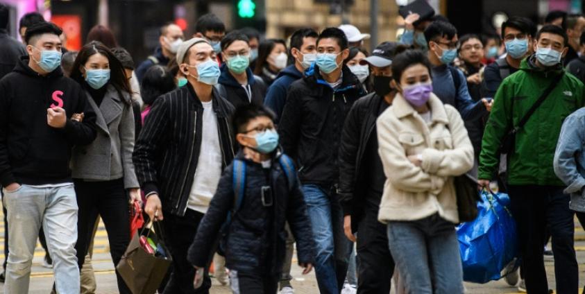 Bangkok Post | Pedestrians wearing face masks cross a road during the Lunar New Year of the Rat public holiday in Hong Kong on Jan 27 as a preventative measure following the coronavirus outbreak which began in the Chinese city of Wuhan.