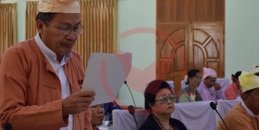 MCL အစီအရင်ခံစာကို ဒေါက်တာအေးဇံက လွှတ်တော်တွင် ဖတ်ကြားတင်သွင်းနေစဉ် (MNA)