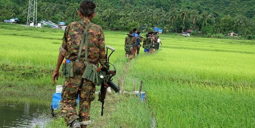 Myanmar soldiers walk in Chain Khar Li Rakhine ethnic village, an area close to fighting at Rathedaung township of northern Rakhine State, western Myanmar, 25 August 2017. Photo: Nyunt Win/EPA