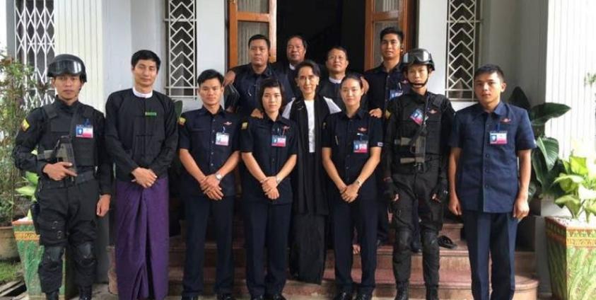 Myanmar State Counsellor and Foreign Minister Aung San Suu Kyi seen closely with security guards during 69th Martyrs' Day at her house in Yangon. Photo: Soe Win/Facebook