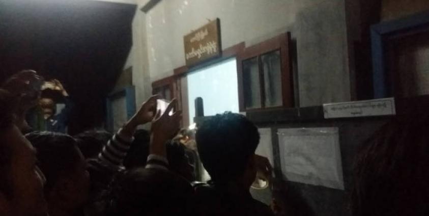 Spectators take photos of a list displaying election results for Taunggyi Township. 