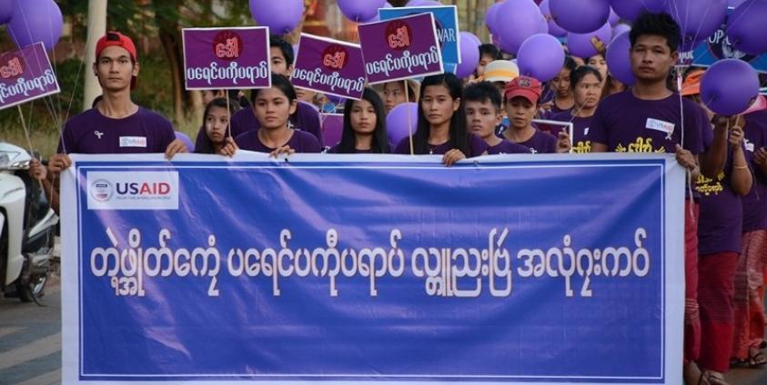 Locals march in Mawlamyine Capital holding the International Day of Elimination of Violence Against Women banner (Photo: MNA)