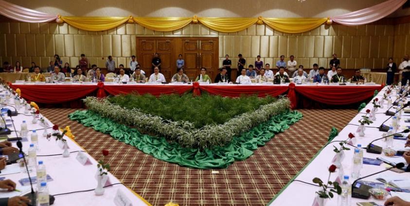 State Counsellor of Myanmar Aung San Suu Kyi (C, back) speaks to members of the Union Peace Dialogue Joint Committee during a meeting in Naypyitaw, Myanmar, 27 May 2016. Photo: Hein Htet/EPA
