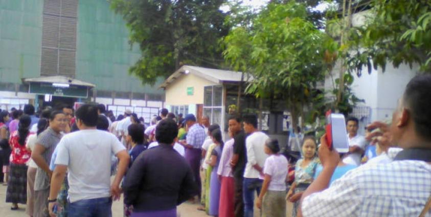 People wait for the arrival of late ballot boxes in a ward in Myawaddy, Karen State.