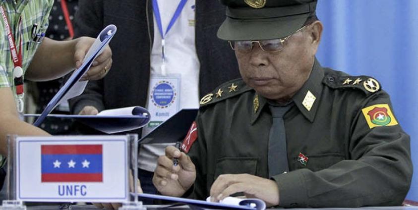 N'Ban La, Chairman of the United Nationalities Federal Council (UNFC), signs a common agreement for a nationwide ceasefire during the Ethnic Armed Organizations Conference in Laiza, Kachin State, Myanmar, 02 November 2013. Photo: Nyein Chan Naing/EPA
