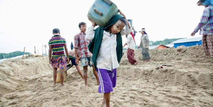 A young child carries sand, Hintada township, Ayeyawaddy region on 13 August 2015. Photo: Hong Sar/Mizzima