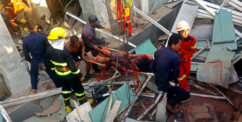 ရိုးမဘဏ် ဗုံးပေါက်ကွဲမှုတွင် ထိခိုက်ဒဏ်ရာရရှိသူ တစ်ဦးအား သယ်ထုတ်လာစဉ်။ ဓာတ်ပုံ - (ဓာတ်ပုံ - သန့်ဇင်လှိုင် MPA/အီးပီအေ)