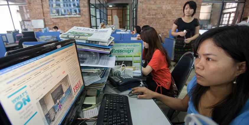 Journalists at work in the news room of of Myanmar Times weekly journal, Yangon, Myanmar. Photo: Lynn Bo Bo/EPA